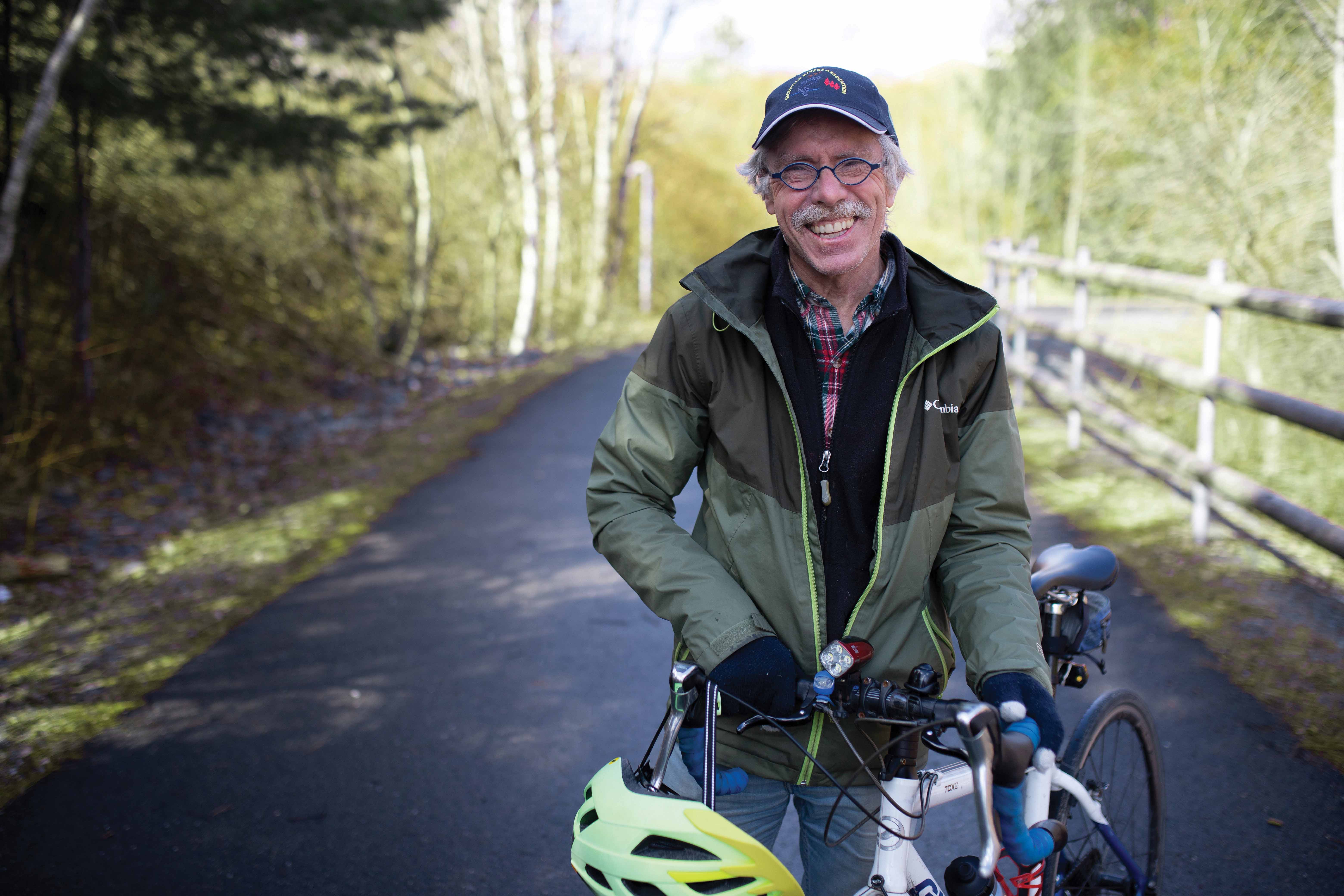 David Waugh holding a bike on the Sackville Greenway