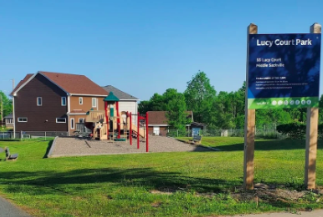 A park surrounded by green grass.