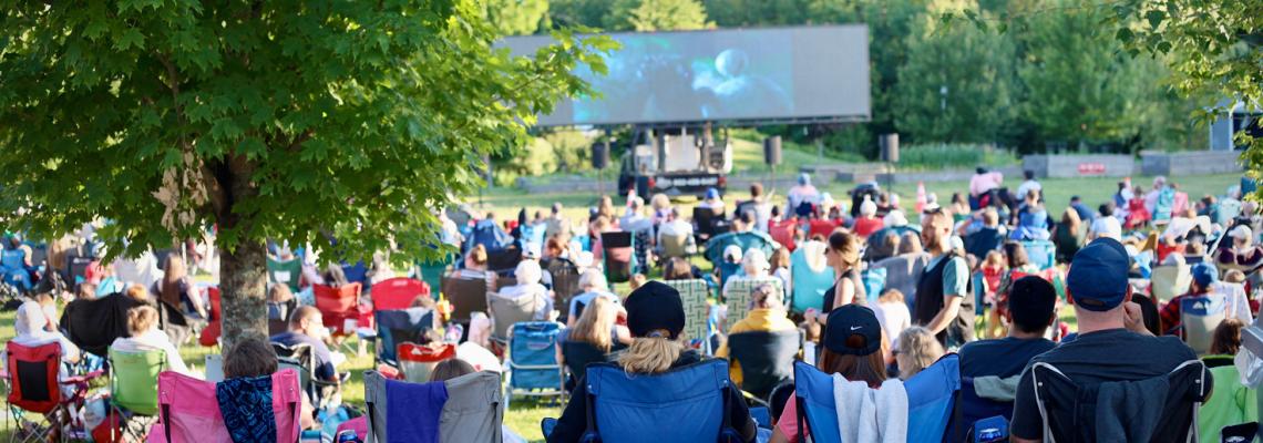 Group of people watching an outdoor movie