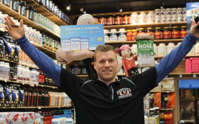 Popeye's Supplements employees in front of merchandise.