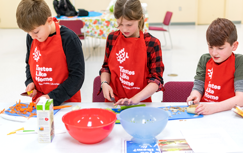 library cooking program three children cutting vegetables 
